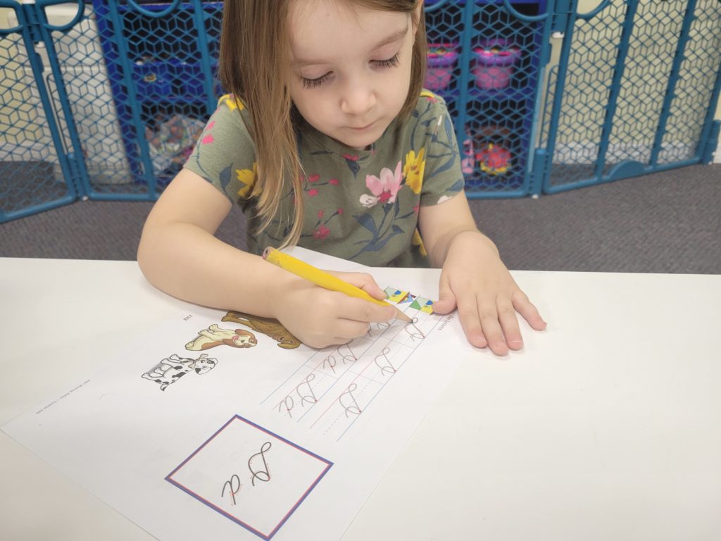 preschool student practicing writing skills